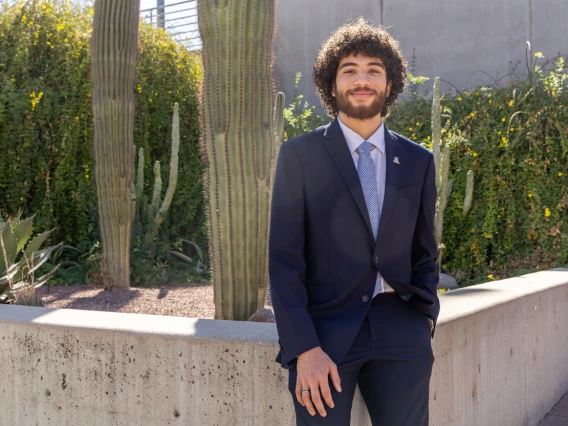 guy sitting in front of saguaro cactus dressed professional